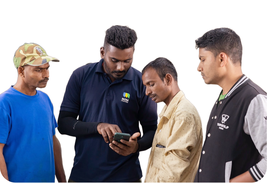 A NOW Money employee shows three workers how to operate the NOW Money mobile bank app.